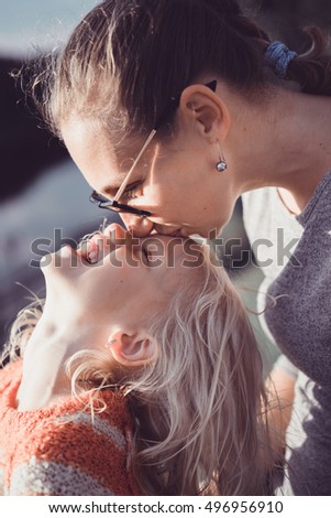 family, children and happy people concept - happy little girl hugging and kissing her mother