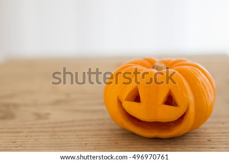 Halloween cute orange pumpkin on an old wooden background