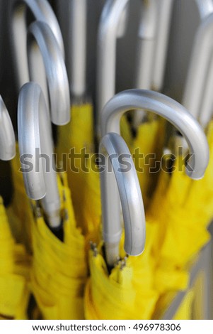 yellow umbrellas with silver handles, top view, vertical photo