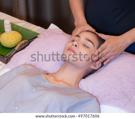 close-up An attractive Caucasian woman getting massaged by a therapist. woman getting head and neck massage by therapist