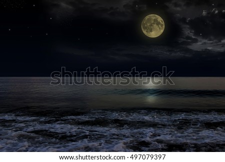 Beautiful magic blue night sky with clouds and full moon and stars and reflexion in water.