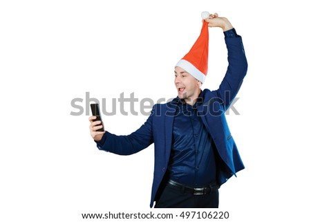 Handsome young man in santa hat making selfie. Isolated on white