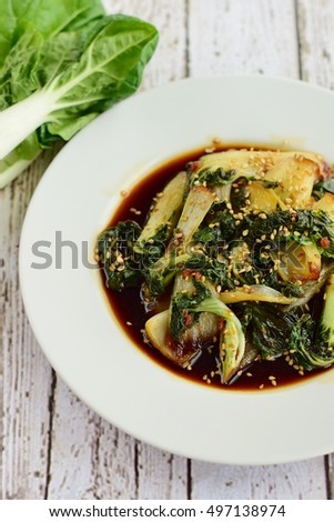 Cooked bok choy with soy sauce and sesame seeds 