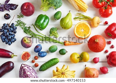 Rainbow colored fruits and vegetables on a white table. Juice and smoothie ingredients. Healthy eating / diet concept. Royalty-Free Stock Photo #497140153