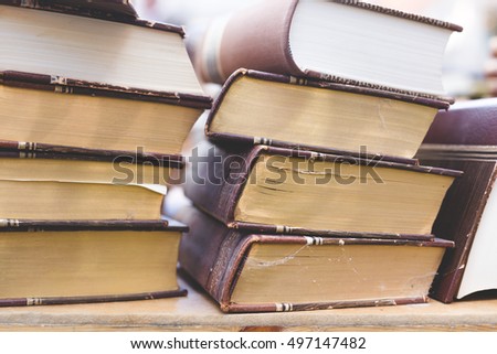 background with old thick obsolete books lying in pile on desk, photography with rustic feeling in antique boutique