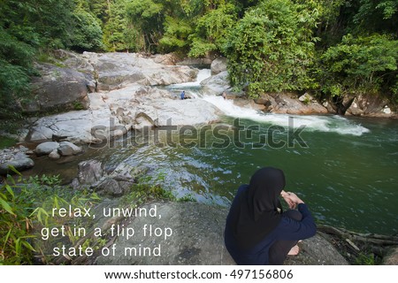 Motivation Quote on photo with a young woman enjoy the scenery of waterfall  backdrop.