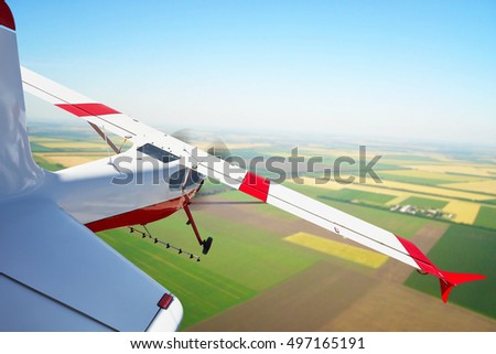 The plane sprays farmers' fields, the plane flies over the ground, aviation in agriculture Royalty-Free Stock Photo #497165191