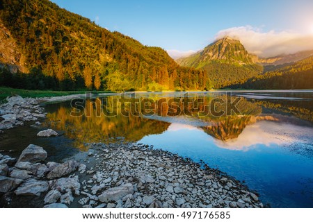 Great view of alpine pond Obersee at twilight. Popular tourist attraction. Picturesque and gorgeous morning scene. Location famous place Nafels, Mt. Brunnelistock, Swiss alps, Europe. Beauty world.