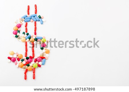 Pills and tablets on white background with dollar symbol in vivid colors
horizontal

