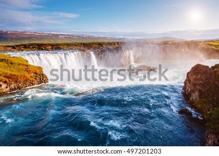 Nice views of the bright sunlit powerful Godafoss cascade. Popular tourist attraction. Unusual and picturesque scene. Location Bardardalur valley, Skjalfandafljot river, Iceland, Europe. Beauty world.