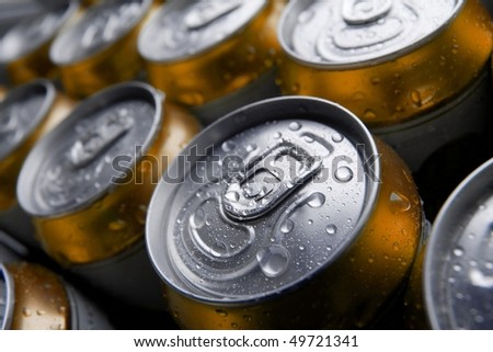 Many cans of cold beer with condensation water droplets