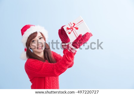 beauty woamn take gift and show something  in christmas isolated on blue background, asian