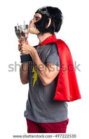 Superhero monkey man holding a trophy