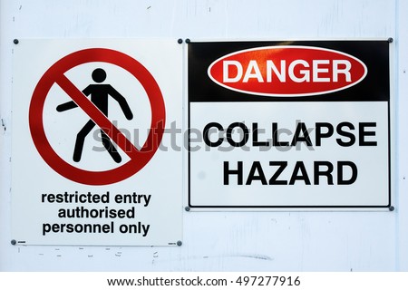 Actual "danger", "collapse hazard" and "restricted entry authorised personnel only" signs with white background and old staple marks