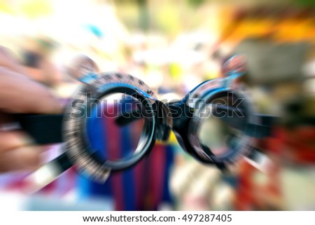 Blurred zoom of Glass optometry test and many types of glasses at glasses shop in market.