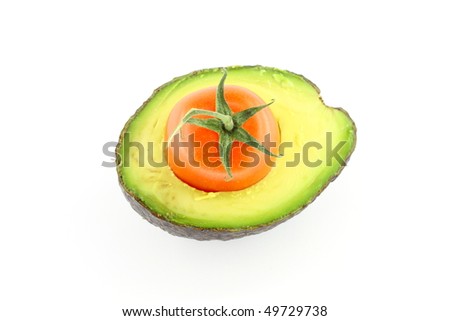 Cross section of avocado with cherry tomato inside
