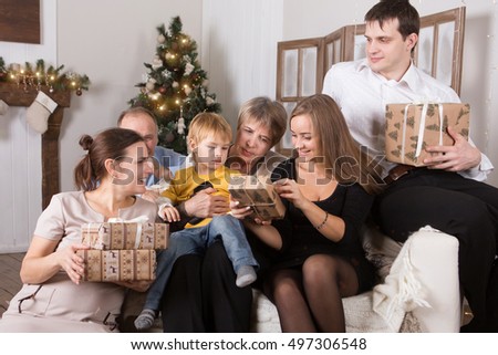 Christmas Family with Kids opening Christmas gifts. Christmas scene.