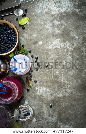 Blueberry with blueberry smoothies and juice. On the stone table.