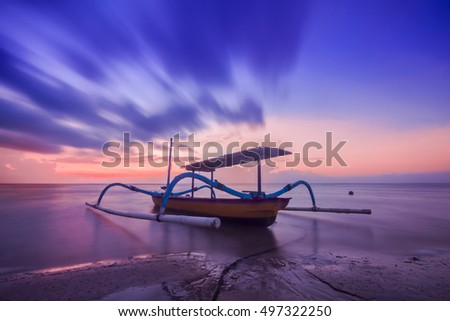 Boat on sea with a reflection in the water at sunset