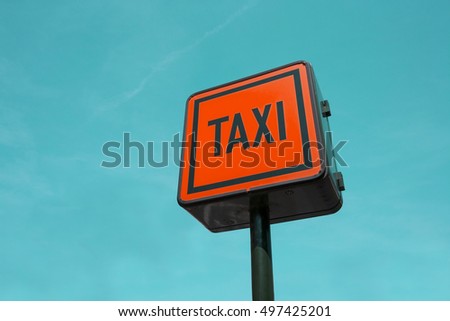 Multi Coloured Taxi Sign against the sky