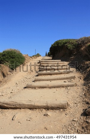 Sandy stairs leading upward to the sky