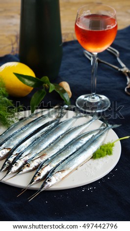 raw fresh needlefish (belonidae family) on the plate ready to cook 