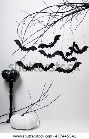 halloween with black bats and pumpkins on a tree on a white background