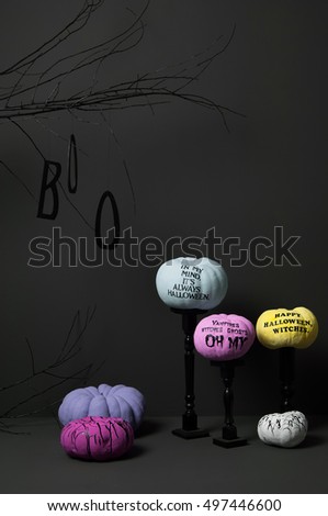 halloween with brightly painted pumpkins and tree on a dark background