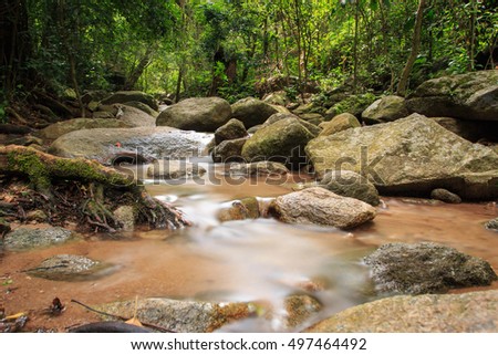 Mystery night at deep tropical rain forest with flowing cascade waterfall. Fantasy jungle landscape.chan ta than thailand