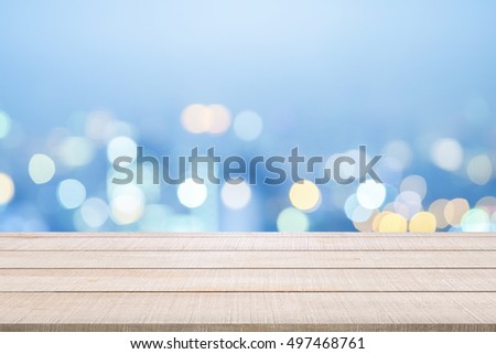 Beige wood table top panel on blue sky blurred background, use for display products or design element in Christmas party or New Year holiday concept