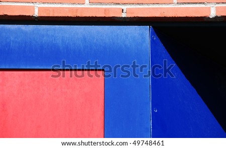 Colorful grunge background of weathered painted wood with a brick top border with a slanted shadow on one side