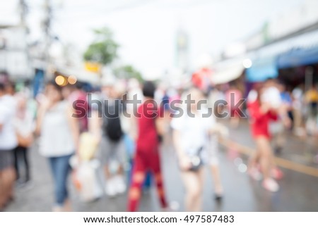 Abstract blur tourist shopping in Chatuchak weekend market outdoor in raining day Bangkok Thailand background
