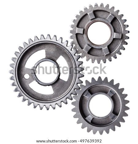 A cluster of interlocking metal gears isolated on a white background.  Royalty-Free Stock Photo #497639392