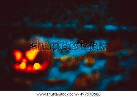 Halloween night blurred background with pumpkin. Soft focus. Shallow DOF