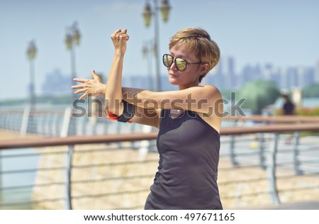 young Asian woman warm up before jogging