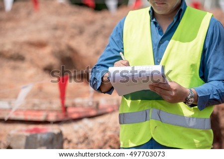 engineer in the act of note record for inspect the construction site Royalty-Free Stock Photo #497703073
