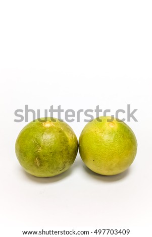 vertical picture of group of two green fresh lime citrus isolated on white background