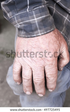   photographed close-up of hand of an old man, lying on the foot