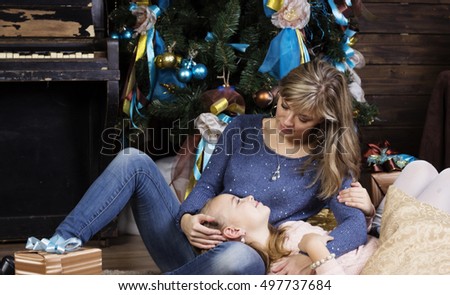 Pretty girl and Mother at Christmas holiday. Concept of traditional world celebration, family holiday. 