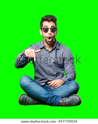 man sitting on the floor pointing down