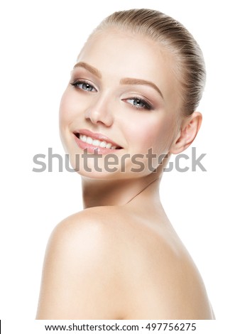 Beautiful face of young smiling woman with clean fresh skin - isolated on white