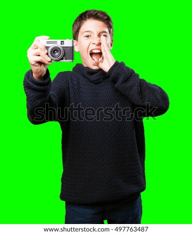 little boy holding a camera