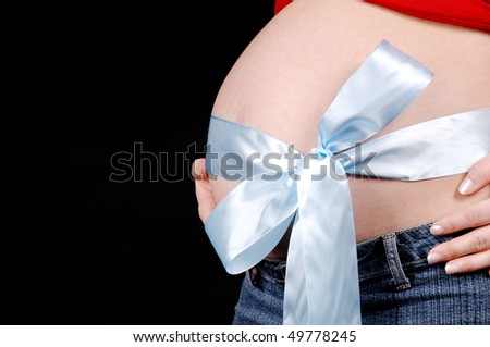 Pregnant belly with blue bow isolated on a white background.