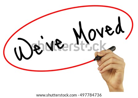Man Hand writing We've Moved with black marker on visual screen. Isolated on white background. Business, technology, internet concept. Stock Photo