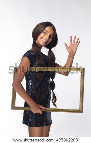 emotional young girl actress brunette with long hair in a black dress with a frame on a white background