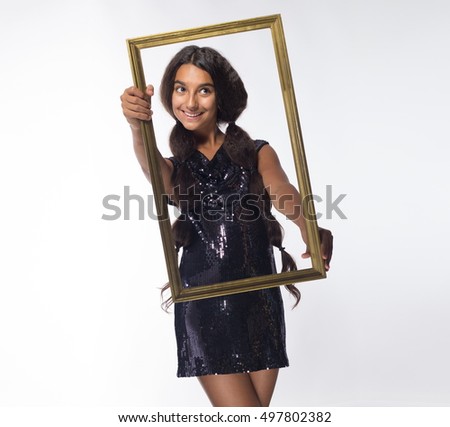 emotional young girl actress brunette with long hair in a black dress with a frame on a white background