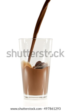 pouring chocolate milk into the glass isolated on white