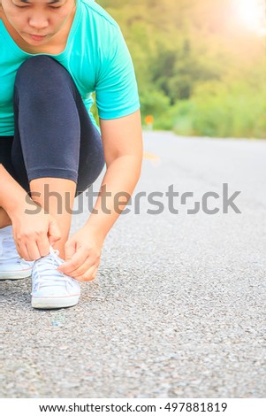 Girl starting running on the road to the nature background on morning