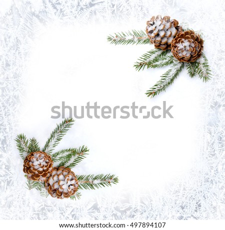Christmas decoration. Frame of cones pine and branch christmas tree on snow on background of frosty pattern of winter window with space for text. Flat lay