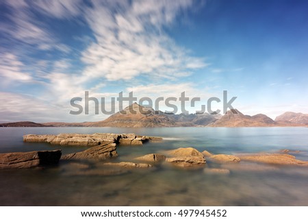 A long exposure from the rocky shore of Elgol on the Isle of Skye, looking over to the Sunlit Cullin mountains.